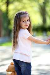 Happy little girl in the green park