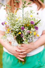 Woman holding wild flowers