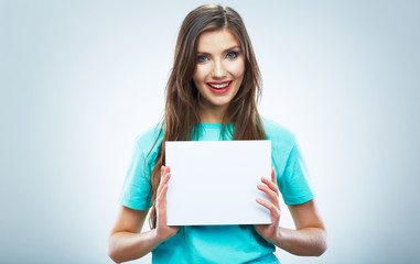 Teenager girl hold white blank paper. Young smiling woman show