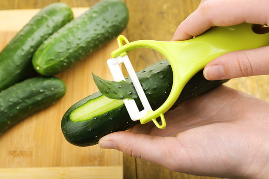 Hands Peeling Cucumber Close Up