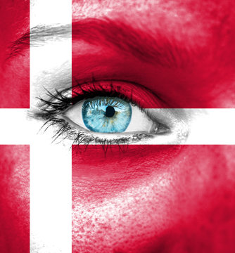 Woman face painted with flag of Denmark