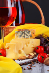 Different kinds of cheese with wine on table close-up