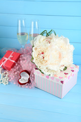 Beautiful wedding bouquet, gift box and wine glasses