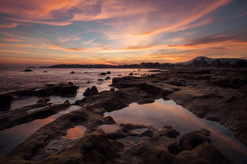 Fototapeta na wymiar beautiful sunset at the rock shore