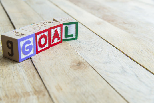 Wooden blocks are Goal word on wooden floor