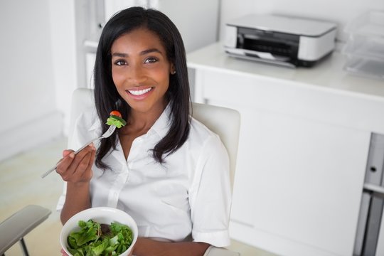 Casual Pretty Businesswoman Eating A Salad At Her Desk