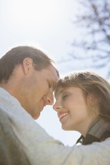 Fototapeta premium Cute couple hugging in the park
