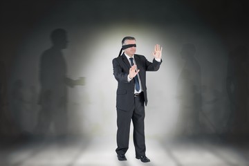 Fototapeta premium Composite image of mature businessman in a blindfold