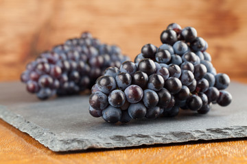 Blue grape clusters on slate board