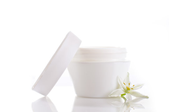 white cream container with white flower