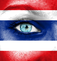 Woman face painted with flag of Thailand