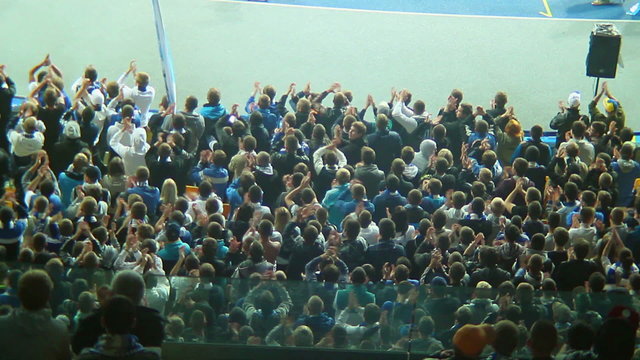 Football fans sector claps and shouts, stadium arena match crowd