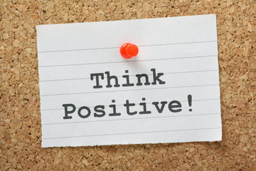 Think Positive message on a cork notice board
