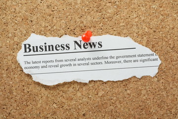 Business News Headline pinned to a cork notice board