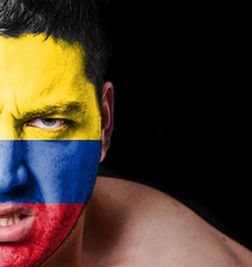 Portrait of angry man with painted flag of Columbia