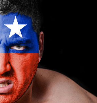 Portrait of angry man with painted flag of Chile