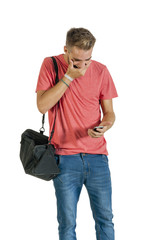 Fototapeta premium Young handsome guy reading message on mobile phone