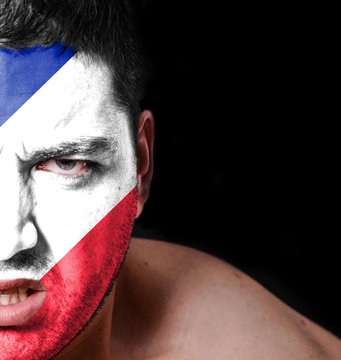 Portrait of angry man with painted flag of France