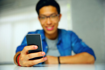 Closeup portrait of a man using smartphone. Focus on smartphone.