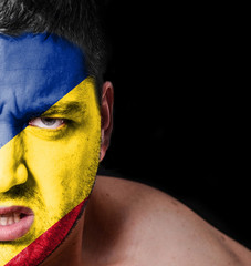 Portrait of angry man with painted flag of Romania