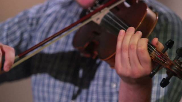 Male plays violin performing at classical concert, music event