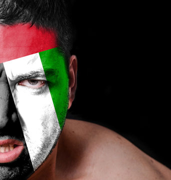 Portrait of angry man with painted flag of United Arab Emirates