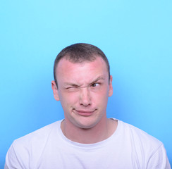 Obraz premium Portrait of girl with funny face against blue background