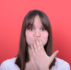 Portrait of amazed girl against red background
