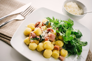 Gnocchi with bacon and arugula