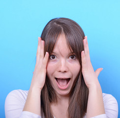 Portrait of girl with shock gesture against blue background