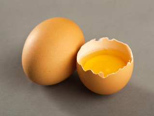 Broken egg isolated on gray background