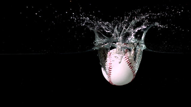 White baseball falling into water
