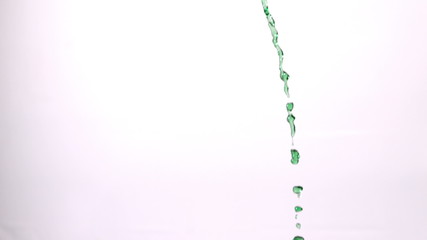Green water pouring across white background - Powered by Adobe