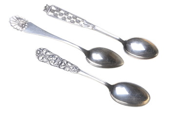 Old silver spoons isolated on white background