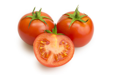 Two tomatoes and one tomato slice with