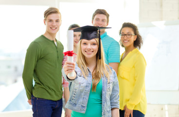 smiling female student with diploma and corner-cap