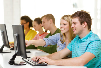 smiling students in computer class at school