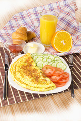 Breakfast with scrambled eggs and croissants