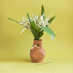 lily-of-the-valley in clay vase
