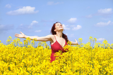 Woman enjoying in a rape field