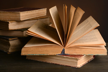 Old books on table on brown background