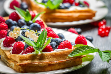 Waffels with cream, blueberry and raspberry