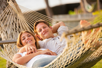 Couple relaxing in tropical hammock