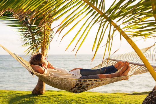 Couple relaxing in tropical hammock