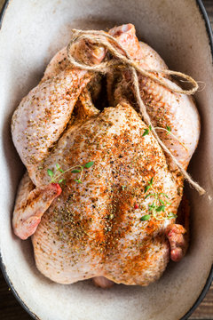 Preparing chicken for cooking with spices