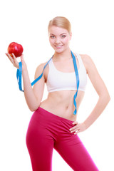 Diet. Fitness woman fit girl with measure tape and apple fruit