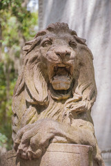 Fototapeta na wymiar Stone Lion Statue in Urban Park