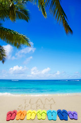 Sign "Team spirit" and color flip flops on sandy beach