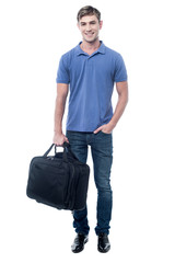 Fototapeta premium Smiling man standing with bag