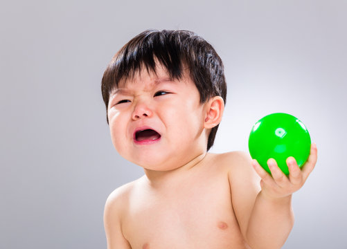 Baby Boy Feeling Unhappy With Holding His Toy